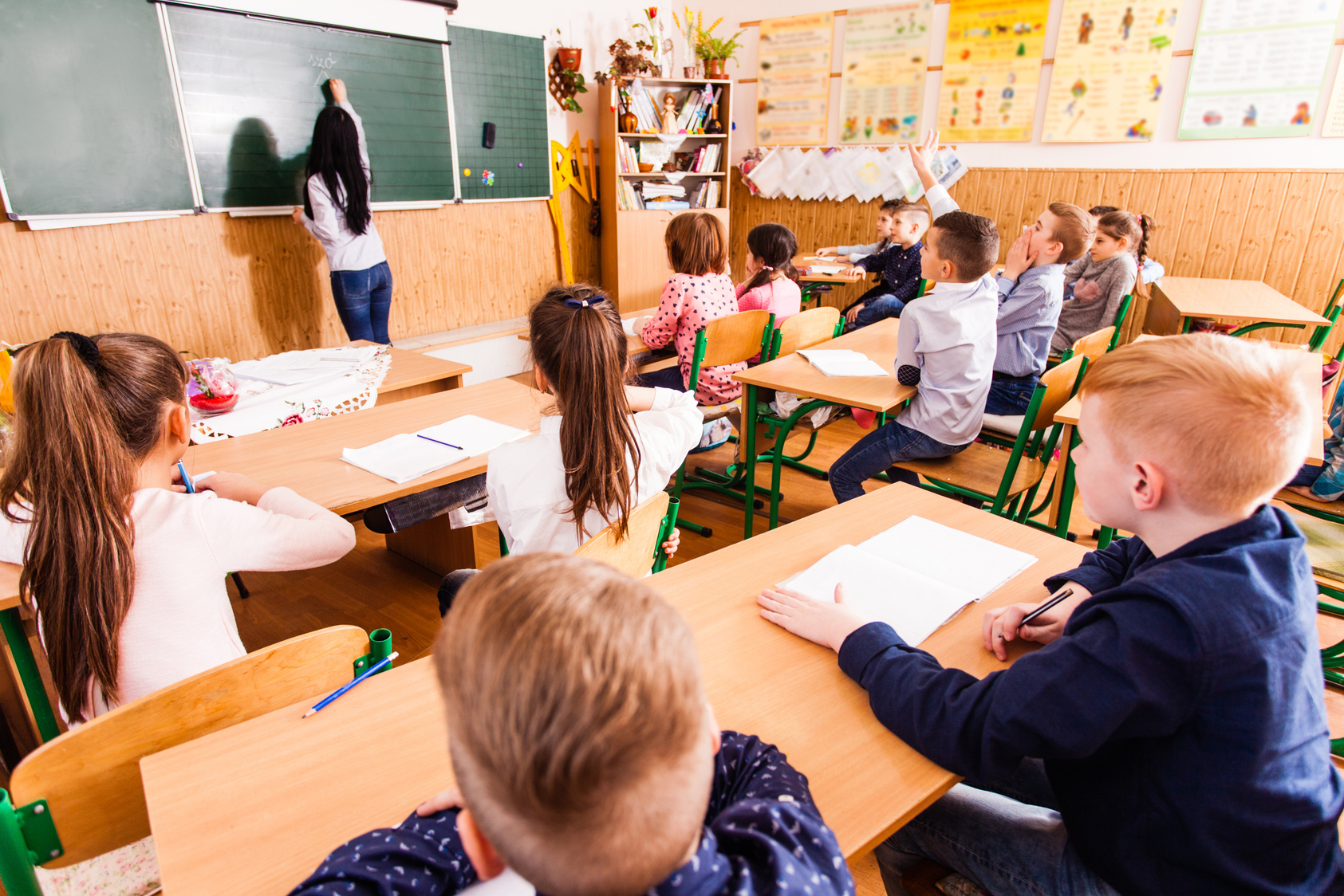 Children Sitting on Desks During Class Lecture 
